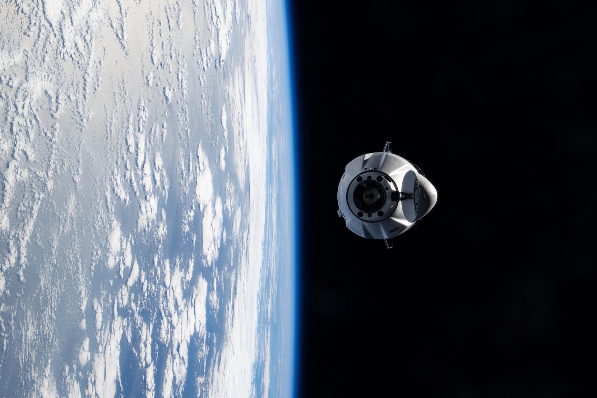 A SpaceX Dragon cargo spacecraft with its nosecone open and carrying over 5,000 pounds of science, supplies, and hardware for NASA's SpaceX CRS-33 mission approaches the International Space Station for an automated docking to the Harmony module's forward port. Both spacecraft were flying 262 miles above the Atlantic Ocean east of the Canadian province of Newfoundland at the time of this photograph.