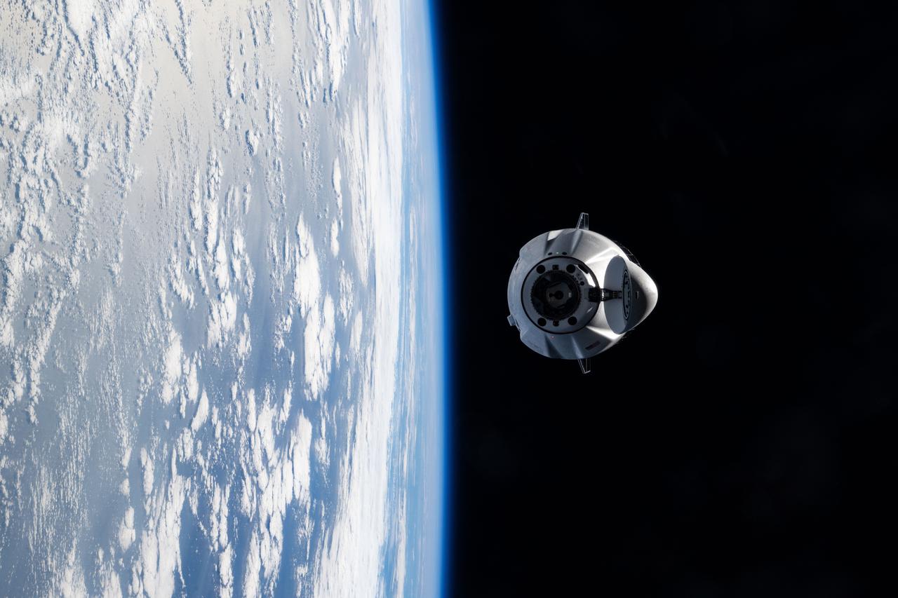 iss073e0545527 (Aug. 25, 2025) --- A SpaceX Dragon cargo spacecraft with its nosecone open and carrying over 5,000 pounds of science, supplies, and hardware for NASA's SpaceX CRS-33 mission approaches the International Space Station for an automated docking to the Harmony module's forward port. Both spacecraft were flying 262 miles above the Atlantic Ocean east of the Canadian province of Newfoundland at the time of this photograph.