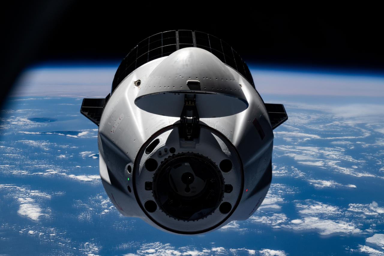 iss073e0545540 (Aug. 25, 2025) --- A SpaceX Dragon cargo spacecraft with its nosecone open and carrying over 5,000 pounds of science, supplies, and hardware for NASA's SpaceX CRS-33 mission approaches the International Space Station for an automated docking to the Harmony module's forward port. Both spacecraft were flying 261 miles above the Atlantic Ocean south of the Azores, a Portuguese archipelago, at the time of this photograph.