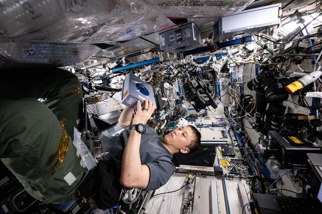 NASA image: NASA astronaut Jonny Kim services a sample processor for a pharmaceutical investigation 