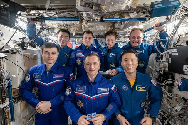 NASA image:  The seven-member Expedition 73 crew gathers for a portrait