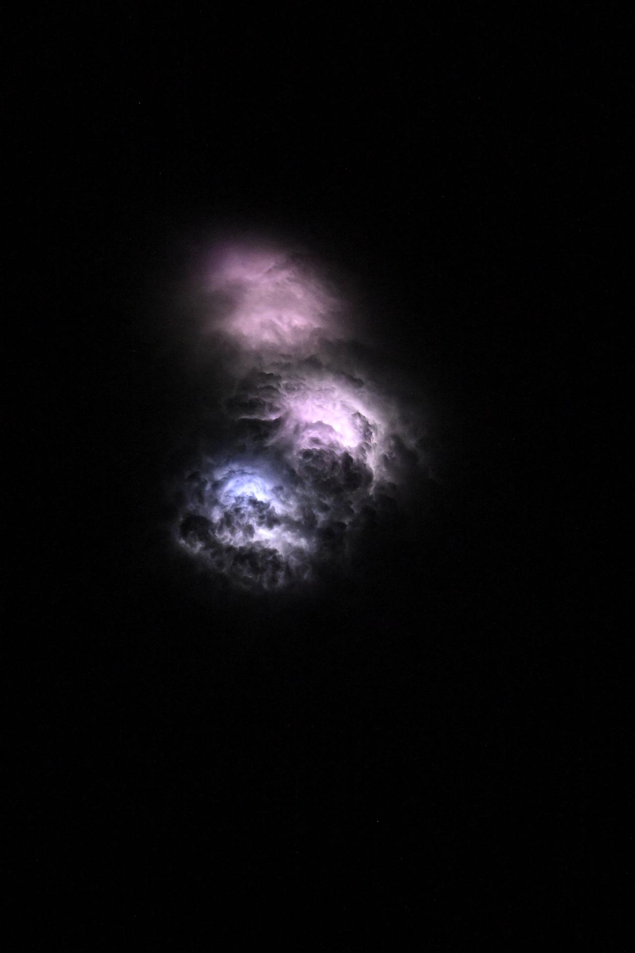 Lightning strikes illuminate the stormy cloud tops above the Democratic Republic of the Congo in this photograph, taken at approximately 9:58 p.m. local time from the International Space Station as it orbited 259 miles above Earth.