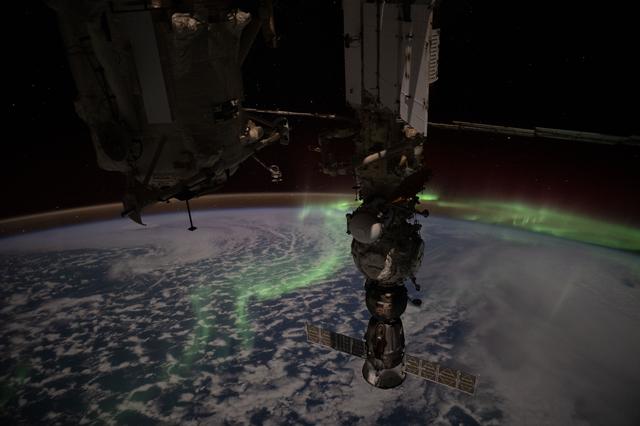 NASA image: The aurora australis streams above the Earth and into the atmospheric glow
