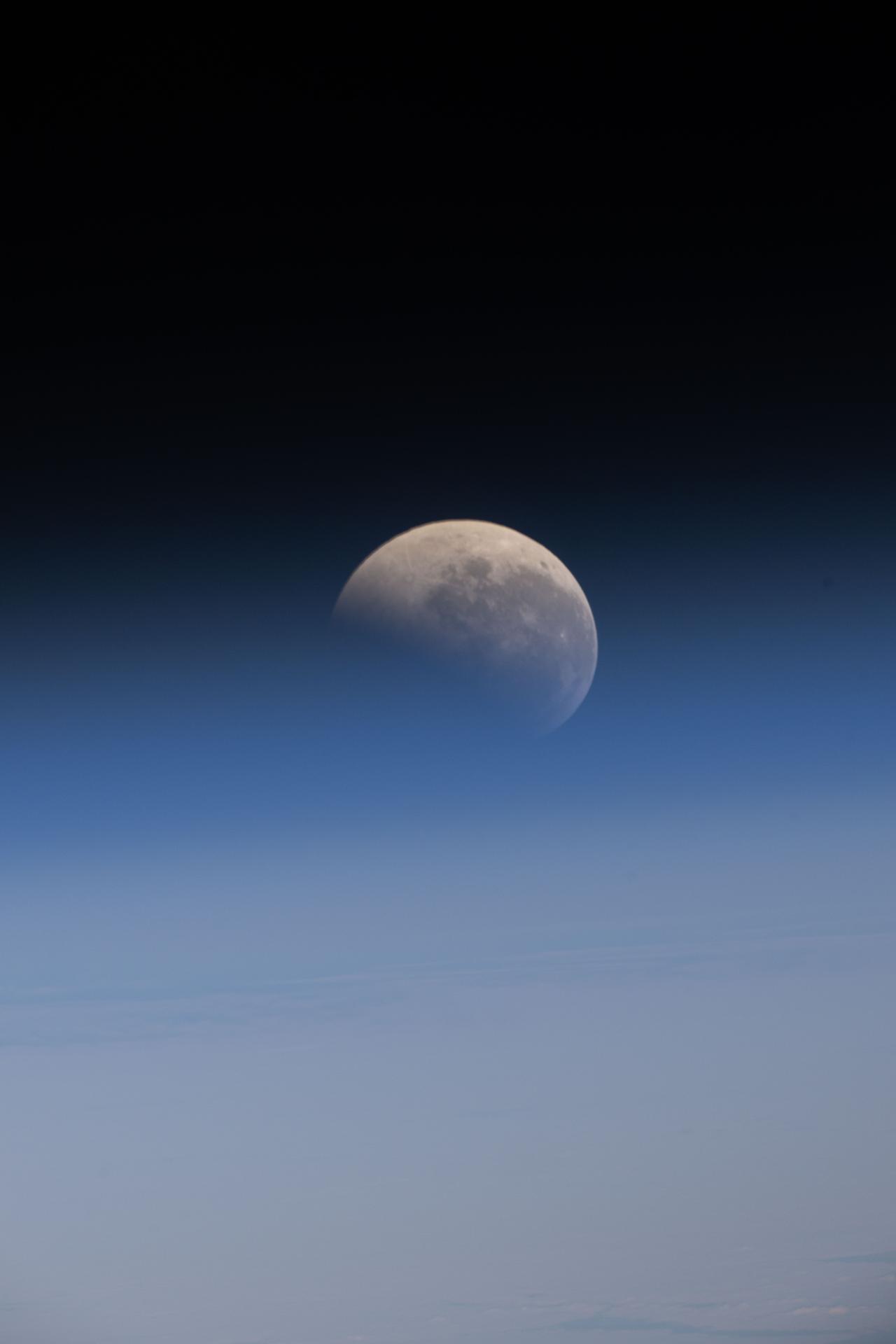 The lunar eclipse, also known as the Blood Moon, is pictured just above Earth's horizon from the International Space Station as it orbited 266 miles above the South Pacific Ocean.