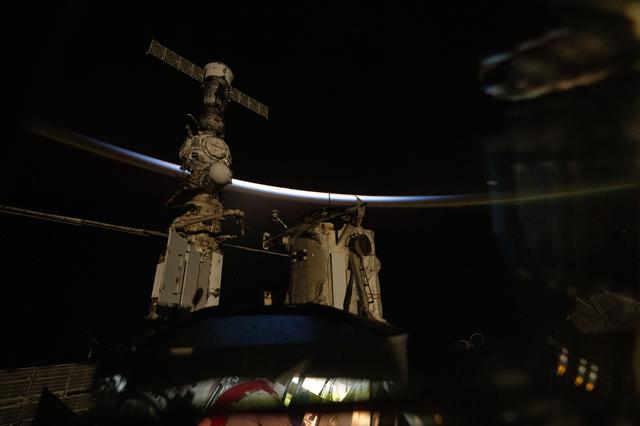 NASA image: The last rays of an orbital sunset outline Earth's horizon