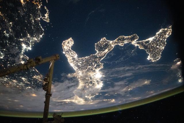 NASA image: The boot of Italy glitters in contrast to the surrounding dark blue seas of southern Europe
