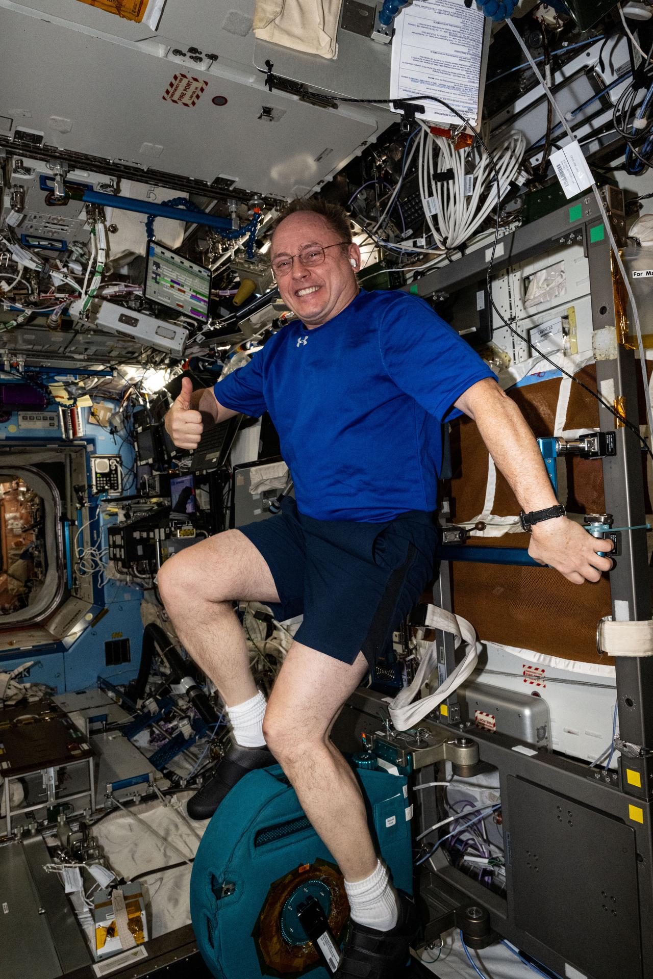 NASA astronaut and Expedition 73 Flight Engineer Mike Fincke pedals on the International Space Station's exercise cycle, also known as Cycle Ergometer with Vibration Isolation and Stabilization, or CEVIS, providing aerobic and cardiovascular conditioning in microgravity.