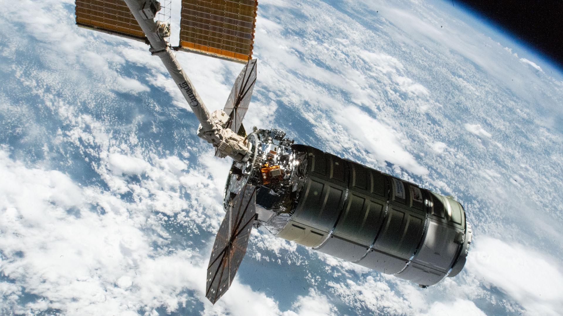Northrop Grumman's Cygnus XL cargo craft, carrying over 11,000 pounds of new science and supplies for the Expedition 73 crew, is pictured in the grips of the International Space Station's Canadarm2 robotic arm following its capture. Both spacecraft were orbiting 257 miles above Tanzania. Cygnus XL is Northrop Grumman's expanded version of its previous Cygnus cargo craft increasing its payload capacity and pressurized cargo volume.