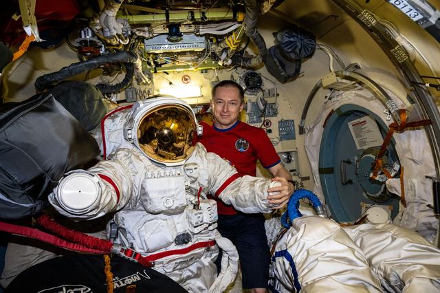 NASA image: Roscosmos cosmonaut Sergey Ryzhikov inspects an Orlan spacesuit 