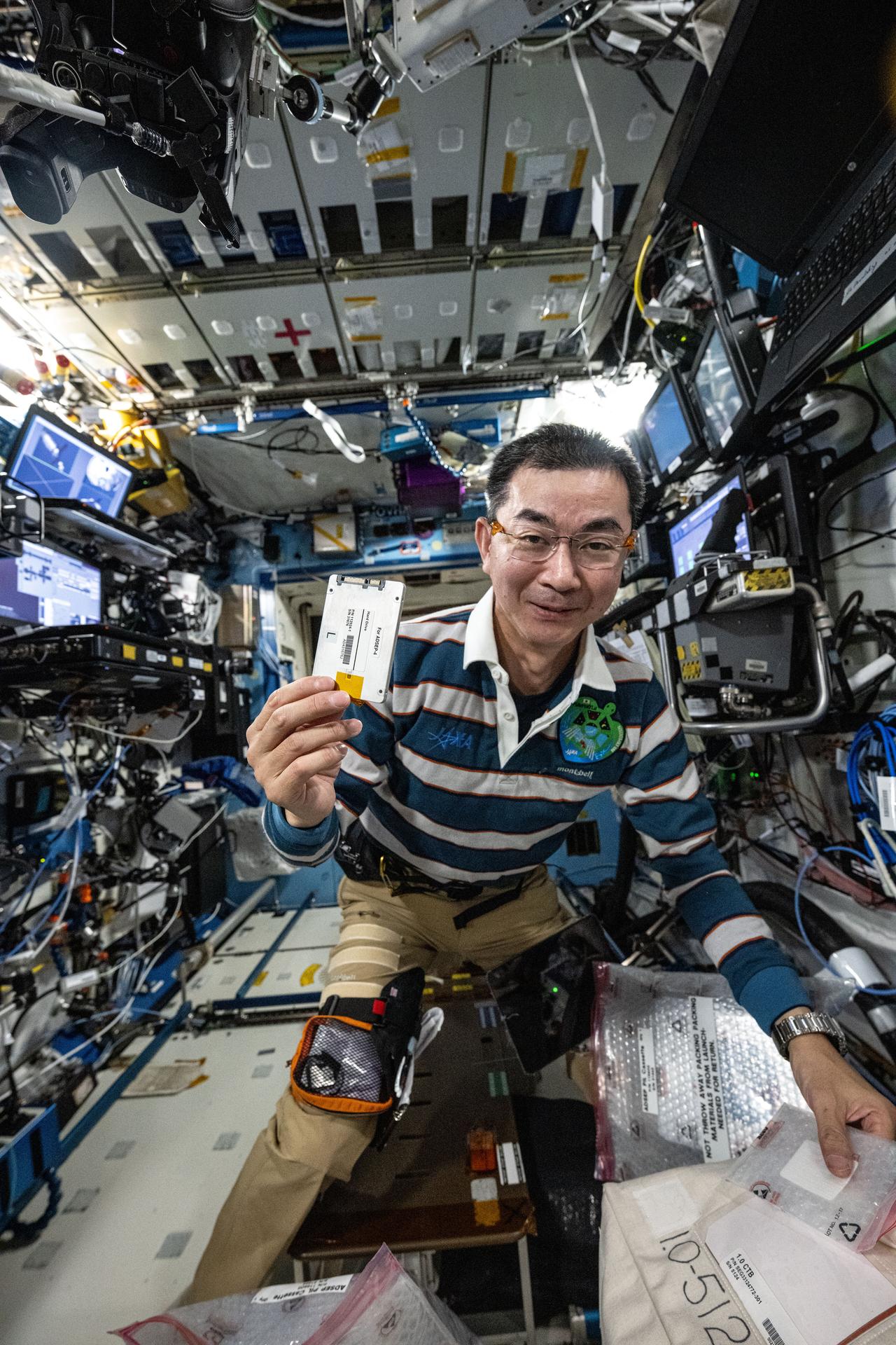 JAXA (Japan Aerospace Exploration Agency) astronaut and Expedition 73 Flight Engineer Kimiya Yui shows off a research hard drive for an investigation exploring how to manufacture advanced pharmaceuticals off the Earth. The hard drive is part of the International Space Station's Advanced Space Experiment Processor-4 (ADSEP-4) that process samples for a variety of biology and physics experiments in microgravity.