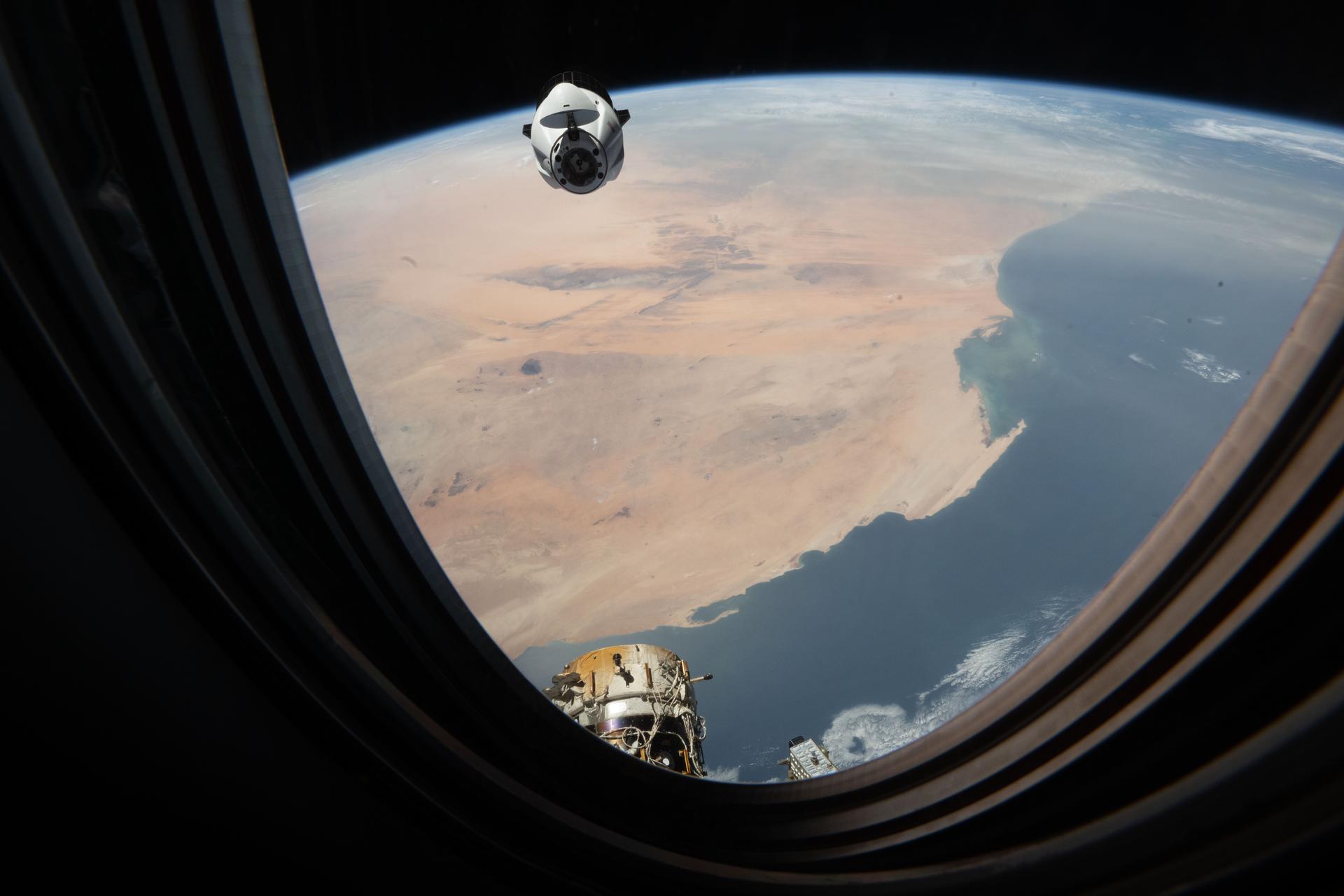 A SpaceX Dragon cargo spacecraft approaches the International Space Station's forward port on the Harmoy module as both spacecraft orbited 260 miles above the Atlantic Ocean off the coast of Western Sahara.