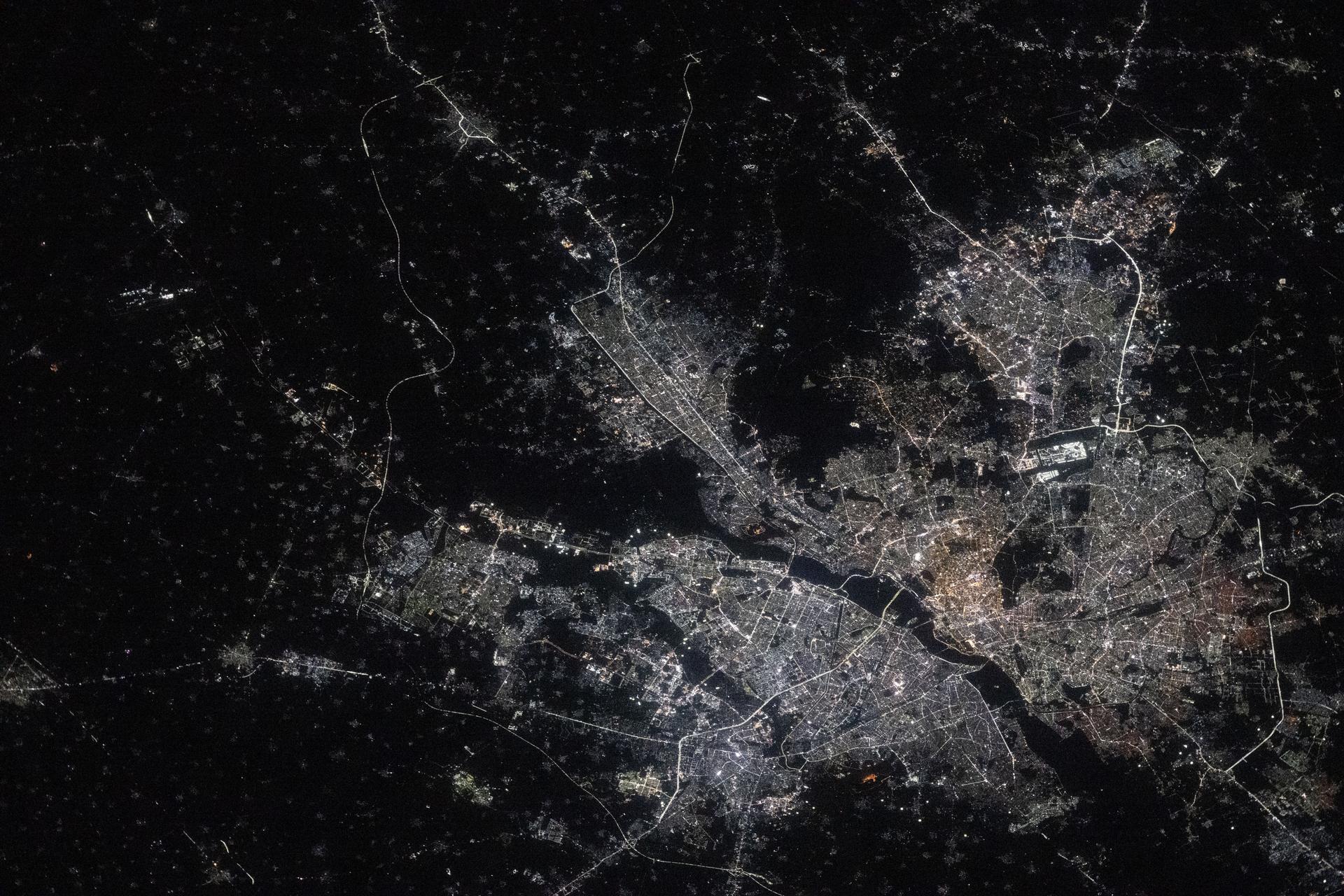 iss073e0763646 (Sept. 21, 2025) --- India’s National Capital Territory of Delhi, home to approximately 34.67 million people, is the second-largest metropolitan area in the world after Tokyo. This nighttime view from the International Space Station, taken at approximately 10:54 p.m. local time, shows the city split by the Yamuna River. The bright rectangular area near the right center marks Indira Gandhi International Airport, one of the busiest aviation hubs in South Asia.