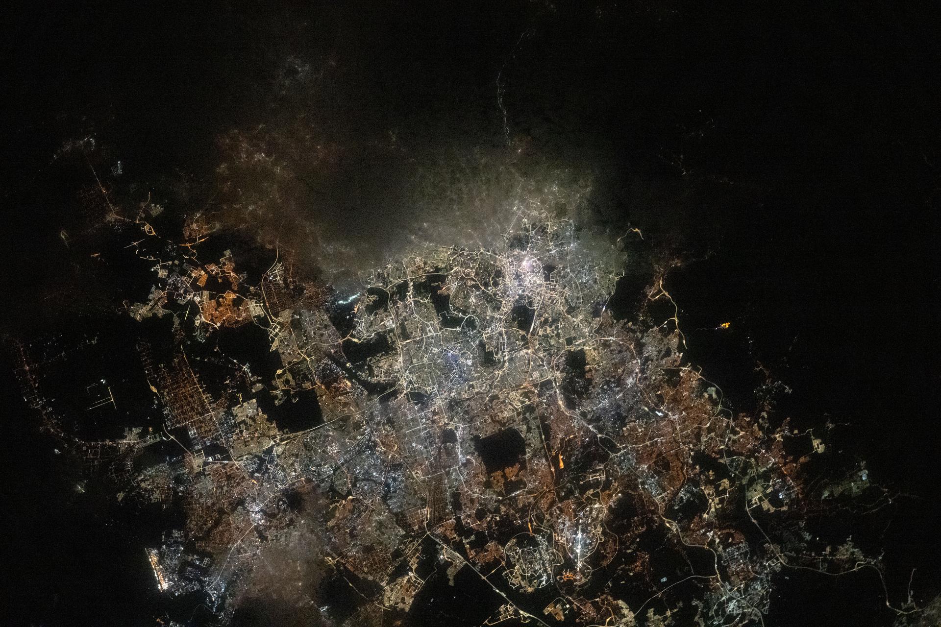 The Greater Kuala Lumpur area of Malaysia, home to approximately 9.1 million people, is pictured from the International Space Station as it orbited 260 miles above Earth at approximately 3:33 a.m. local time. Dark patches scattered throughout the urban landscape mark nature preserves and parks, many of which feature dams, waterfalls, and hiking trails.