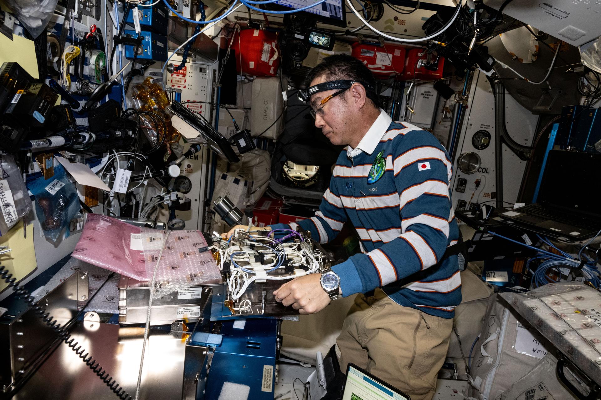 JAXA (Japan Aerospace Exploration Agency) astronaut and Expedition 73 Flight Engineer Kimiya Yui prepares new computer networking gear for installation inside the International Space Station's Kibo laboratory module. The ethernet hub upgrades will transmit data quicker and more efficiently throughout the orbital outpost.