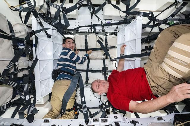 NASA image: Astronauts Kimiya Yui and Mike Fincke pictured inside the Cygnus XL cargo craft