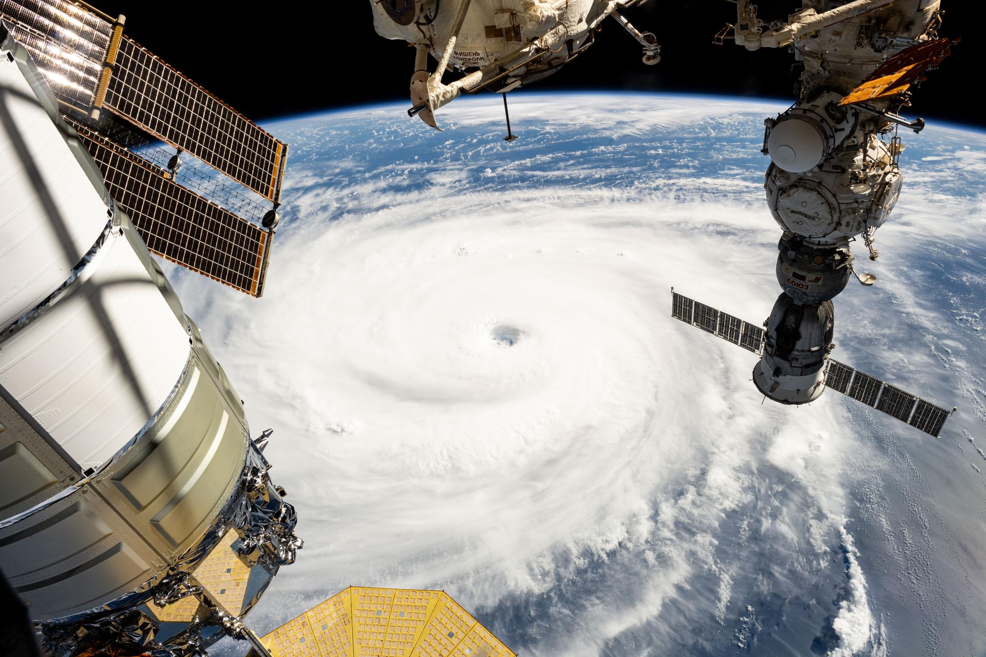 Typhoon Neoguri with its well-defined eye is pictured in the Pacific Ocean from the International Space Station as it orbited 258 miles above. In the right foreground, is the Soyuz MS-27 spacecraft docked to the Prichal module. At left, is a portion of the Northrop Grumman Cygnus XL cargo craft berthed to the Unity module.