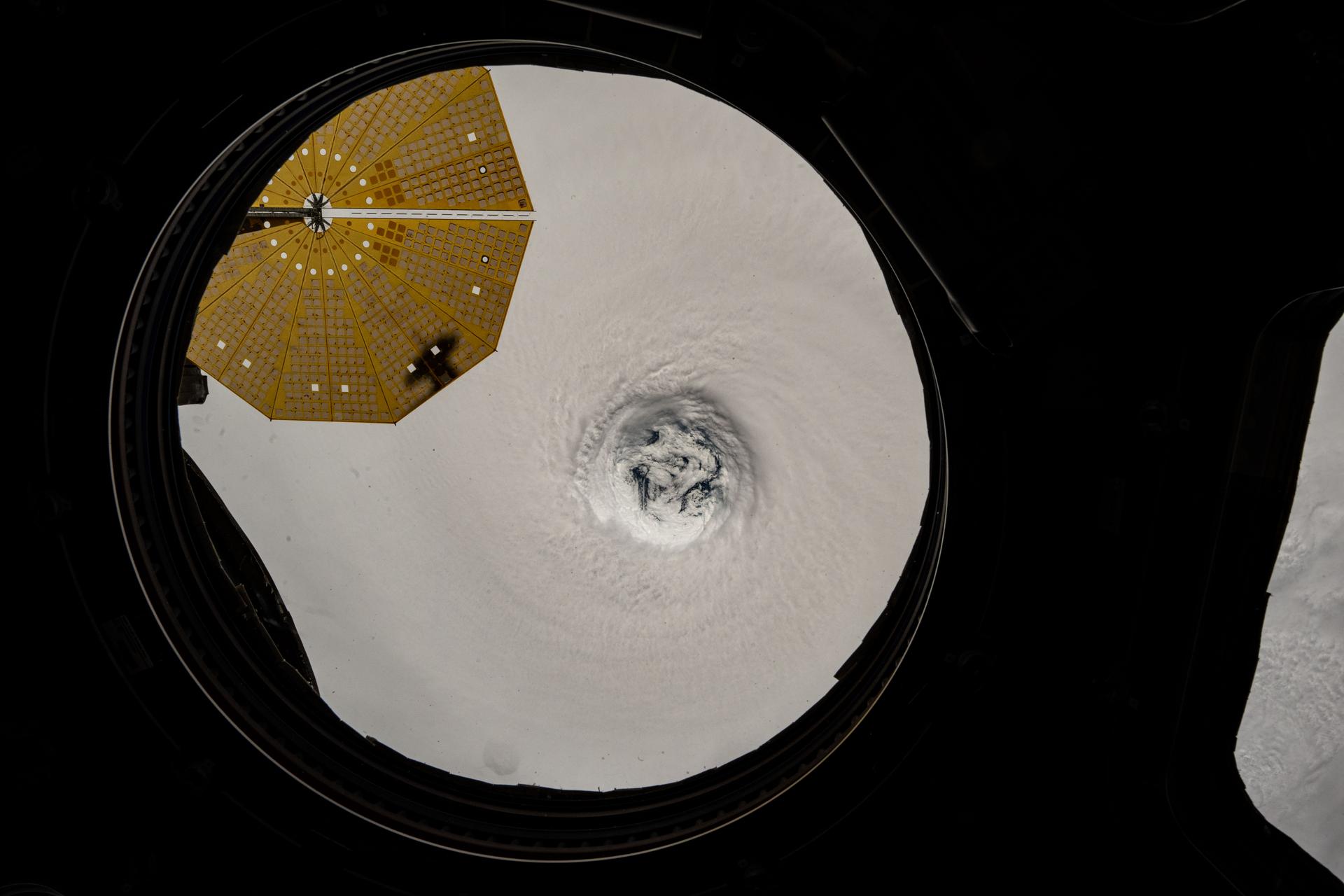 This near overhead view from the main window on the International Space Station's cupola shows the well-defined eye of Typhoon Ragasa. The orbital outpost was soaring 256 miles above the South China Sea north of Philippines' island of Luzon at the time of this photograph. At upper left, is one of two cymbal-shaped UltraFlex solar arrays that powers the Northrop Grumman Cygnus XL cargo craft.