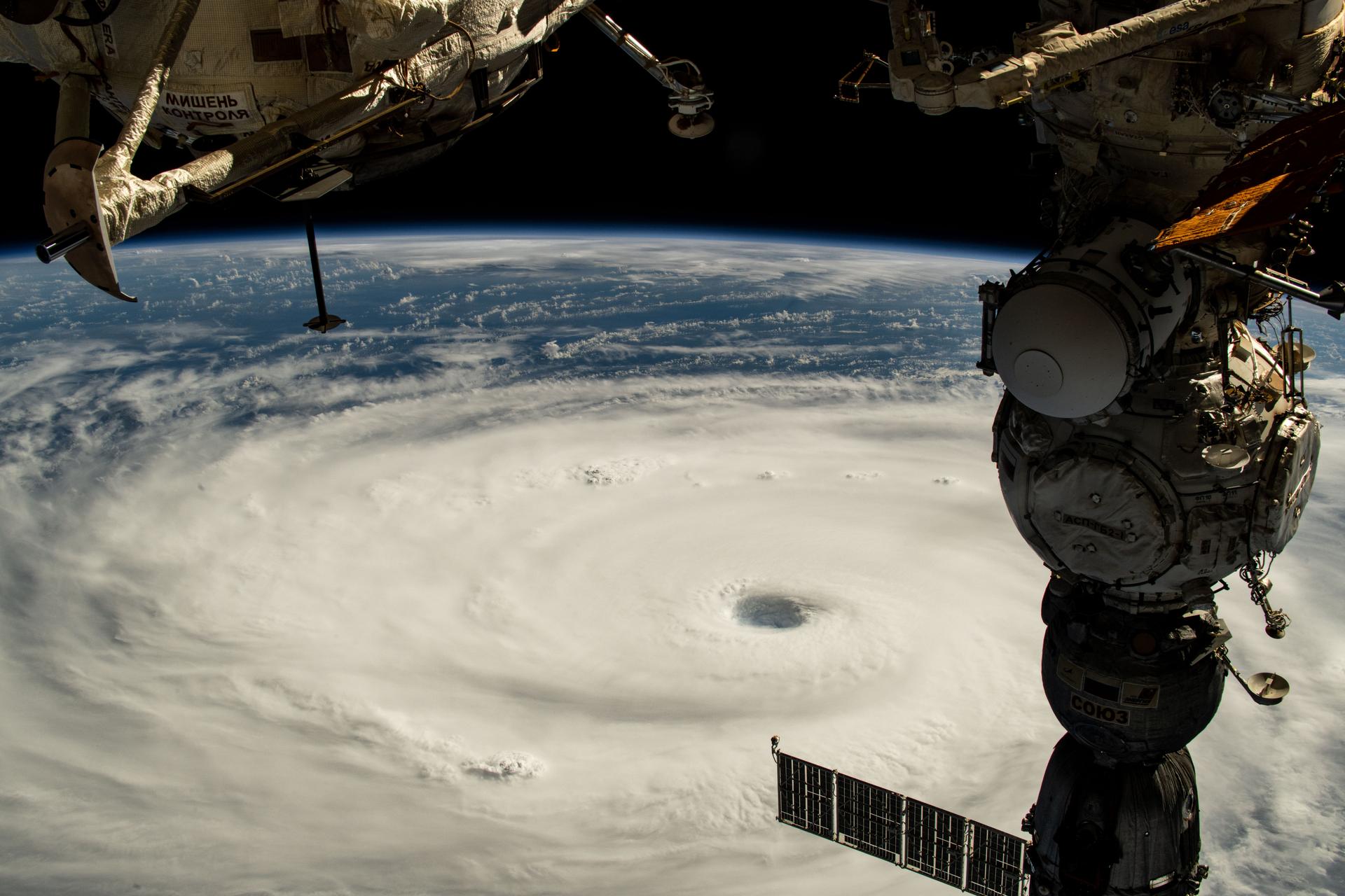 Typhoon Neoguri with its well-defined eye is pictured in the Pacific Ocean from the International Space Station as it orbited 258 miles above. In the right foreground, is the Soyuz MS-27 spacecraft docked to the Prichal module.