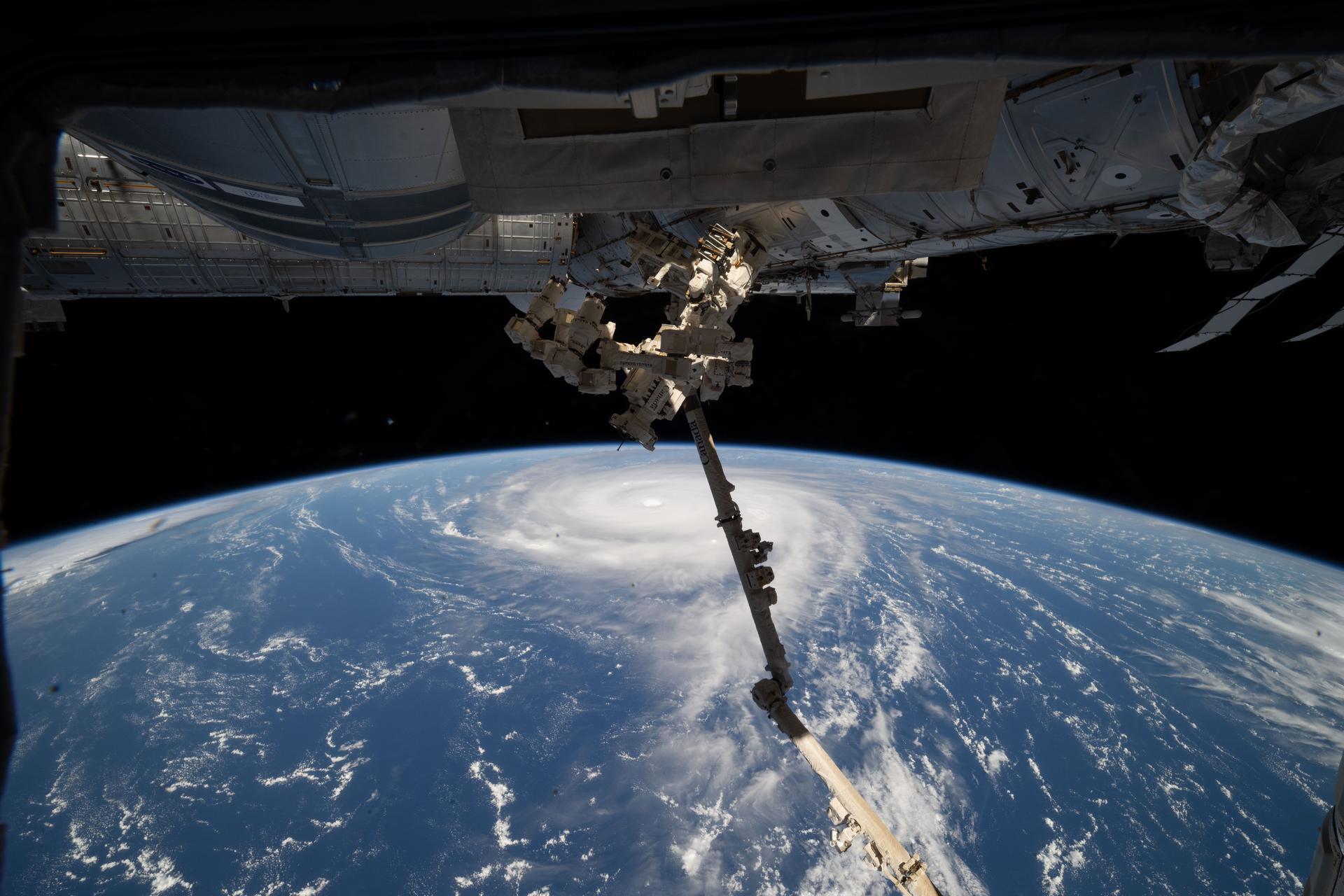 Typhoon Neoguri is pictured from the International Space Station as it orbited 257 miles above the Pacific Ocean southeast of Japan. In the center foreground, the Canadarm2 robotic arm extends from the orbital outpost.