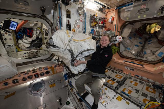 NASA image: NASA astronaut Zena Cardman unpacking new hardware from the Cygnus XL