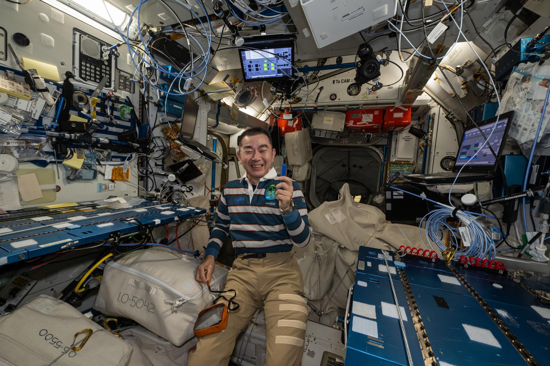 JAXA (Japan Aerospace Exploration Agency) astronaut and Expedition 73 Flight Engineer Kimiya Yui smiles for a portrait during weekend housecleaning activities inside the International Space Station's Harmony module.