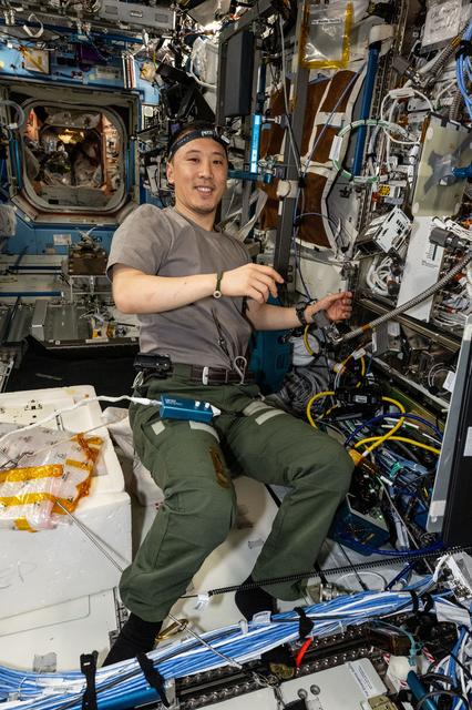 NASA image: NASA astronaut Jonny Kim replaces computer hardware inside the Cold Atom Lab