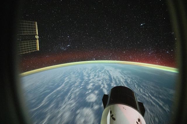 NASA image: Clouds stretch into a soft blur and a bright airglow blankets Earth’s horizon