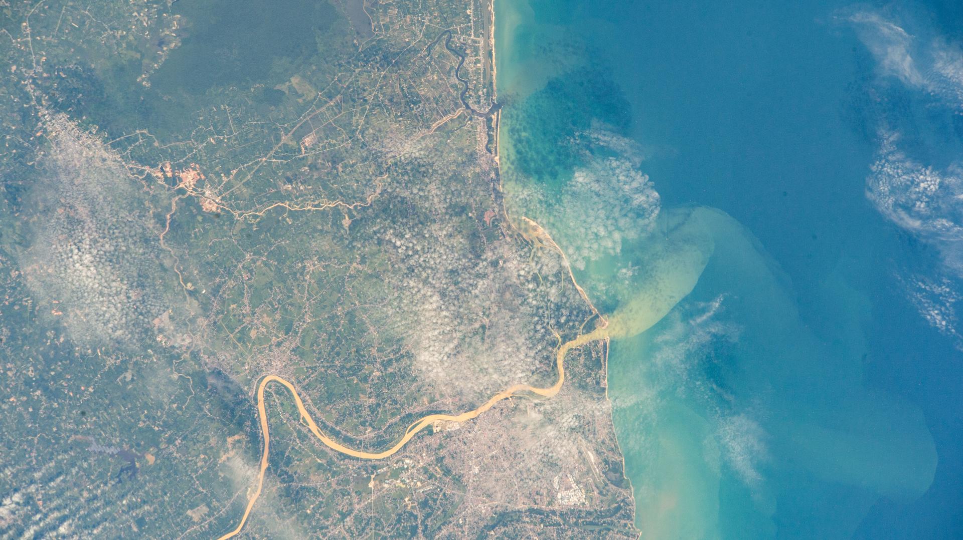 The Kelantan River flows through one of Malaysia’s most densely populated floodplains before emptying into the South China Sea. On its eastern bank, where the river meets the sea, lies Kota Bharu, a city founded in the late 19th century and home to approximately 570,000 people. This photograph was taken from the International Space Station as it orbited 260 miles above Earth.