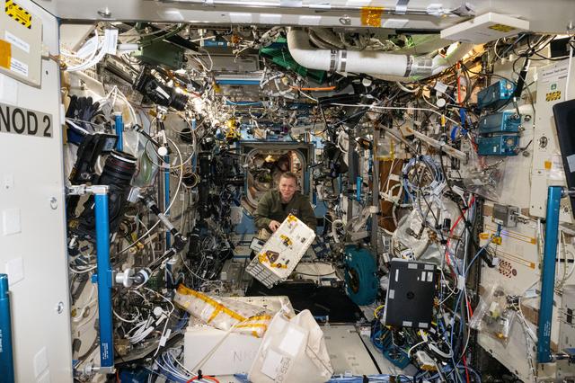 NASA image: NASA astronaut Zena Cardman transfers the Advanced Space Experiment Processor-2