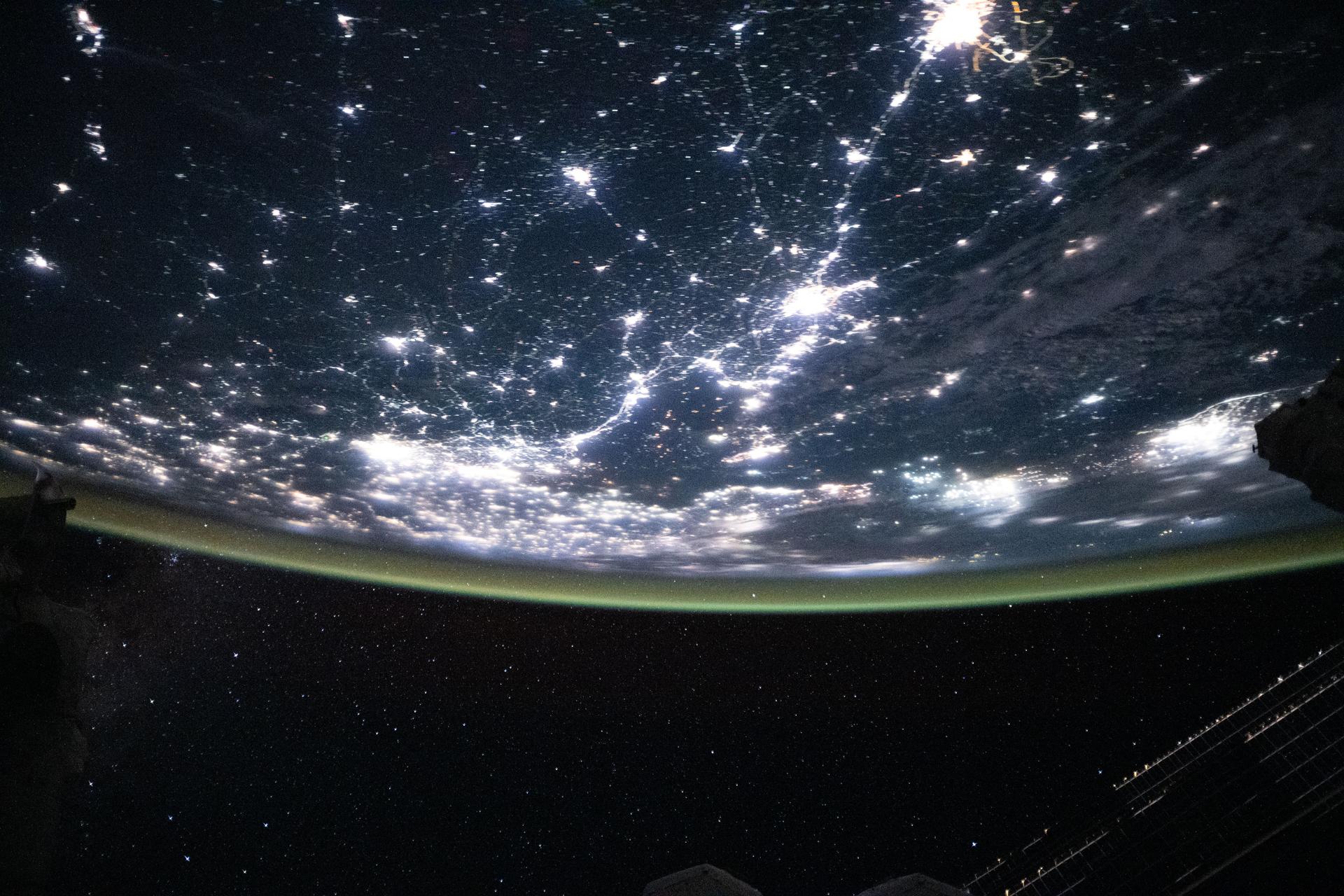The densely urbanized region surrounding the Bohai Sea (center) on China's east coast includes several major metropolitan areas, from Beijing (left center) to Changchun (top right), and Seoul, South Korea (far right). A yellow-green airglow blankets Earth's horizon in this image captured from the International Space Station as it orbited 263 miles above the surface at approximately 11:06 p.m. local time.