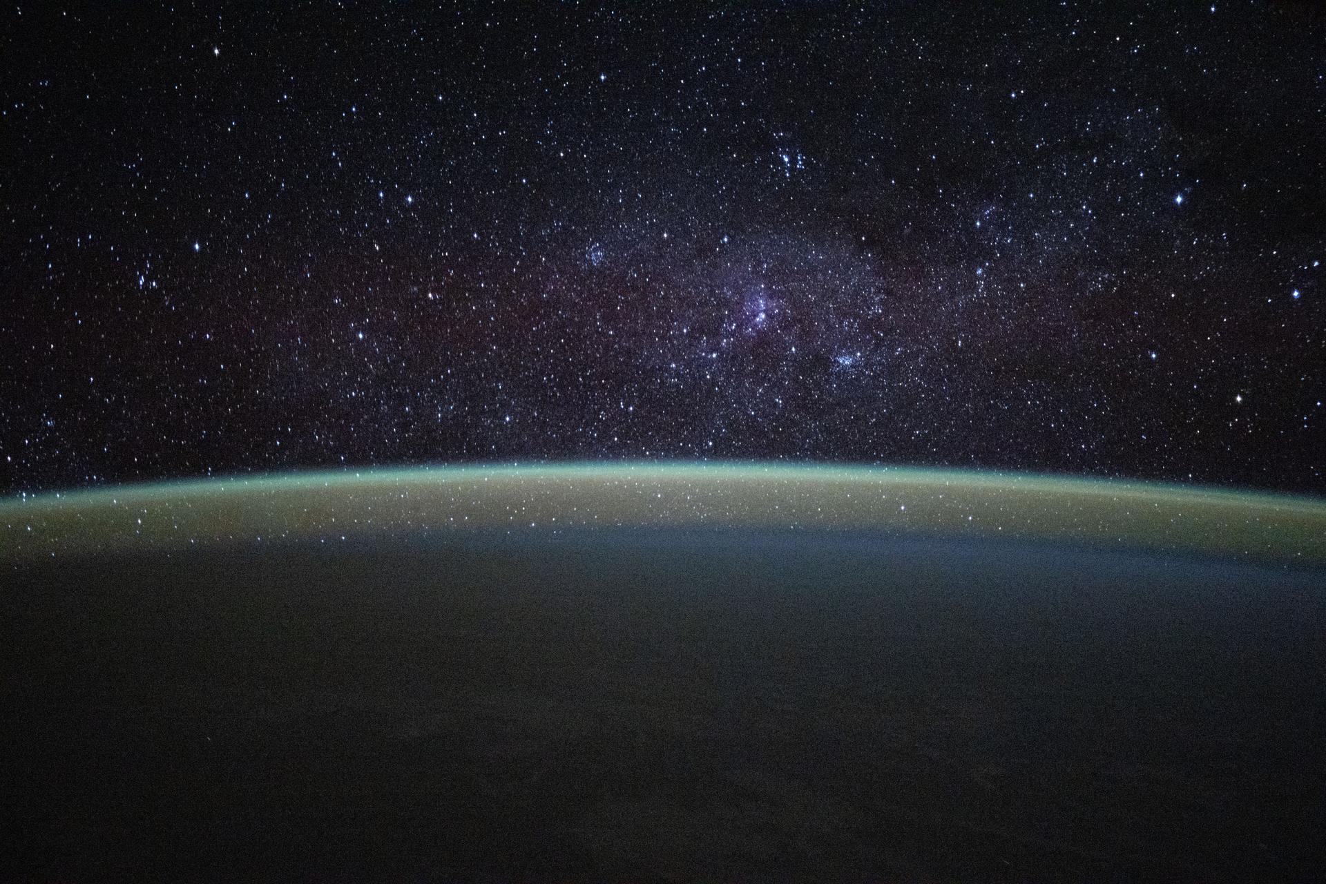 Stars fill the sky above a serene, blue-green airglow blanketing Earth's horizon in this photograph taken from the International Space Station at approximately 1:05 a.m. local time while orbiting 263 miles above the Republic of Mauritius in the Indian Ocean.