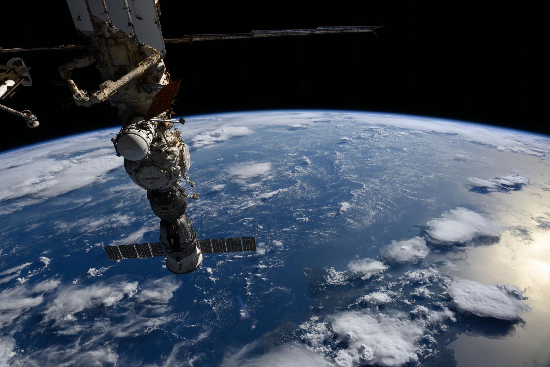 The Soyuz MS-27 crew spacecraft is pictured docked to the International Space Station's Prichal module as the orbital outpost soared 257 miles above a gleaming blue Atlantic Ocean, north of the Dominican Republic.