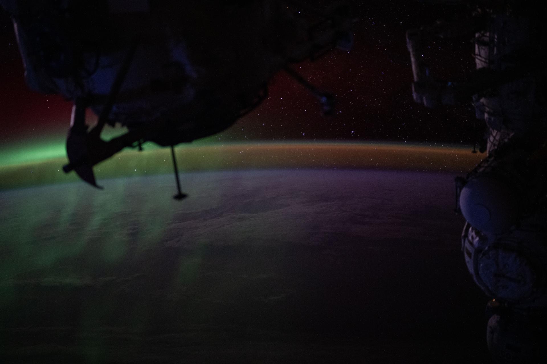 iss073e0865646 (Sept. 28, 2025) --- A wispy green aurora australis fades into a dim orange-yellow airglow above Earth’s horizon in this photograph taken at approximately 2:31 a.m. local time from the International Space Station, as it orbited 270 miles above the Indian Ocean, south of Perth, Australia.