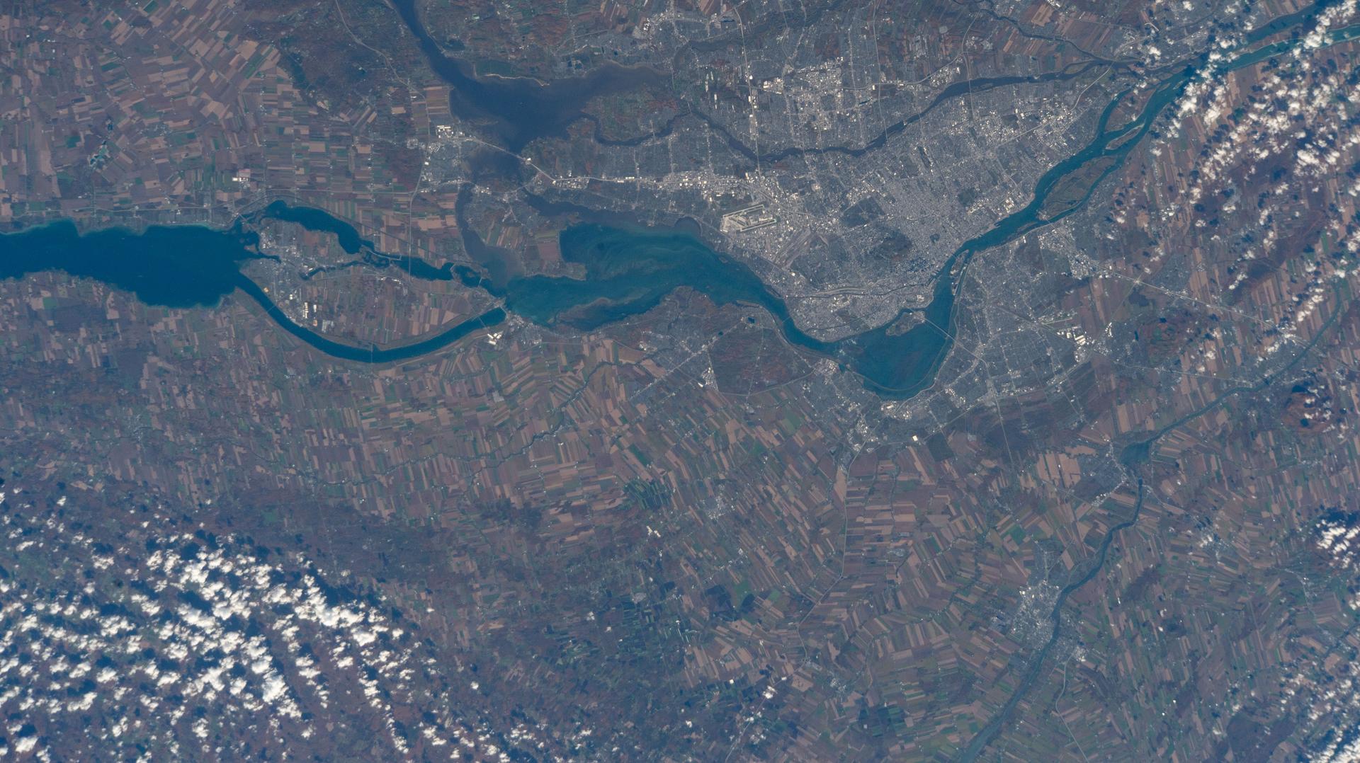 Montreal, Quebec, the second-most populous Canadian city with a metropolitan population of about 4.29 million, sits between the Prairies River to its north and the St. Lawrence River to the south. Montreal is named after Mount Royal, a prominent and natural landmark in the heart of the city. Montréal-Pierre Elliott Trudeau International Airport, voted North America's cleanest airport in 2025, is pictured near the bank of the St. Lawrence from the International Space Station as it orbited 263 miles above the Earth.