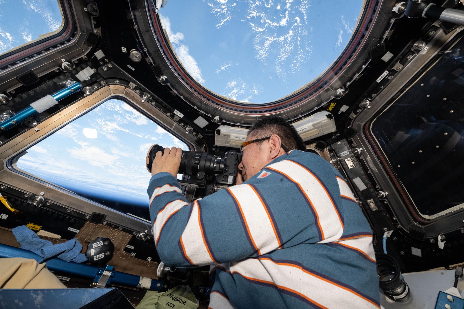 JAXA (Japan Aerospace Exploration Agency) astronaut and Expedition 73 Flight Engineer Kimiya Yui points a camera out a cupola window and photographs external International Space Station hardware. The orbital outpost was soaring 262 miles above the Atlantic Ocean west of Spain at the time of this photograph.