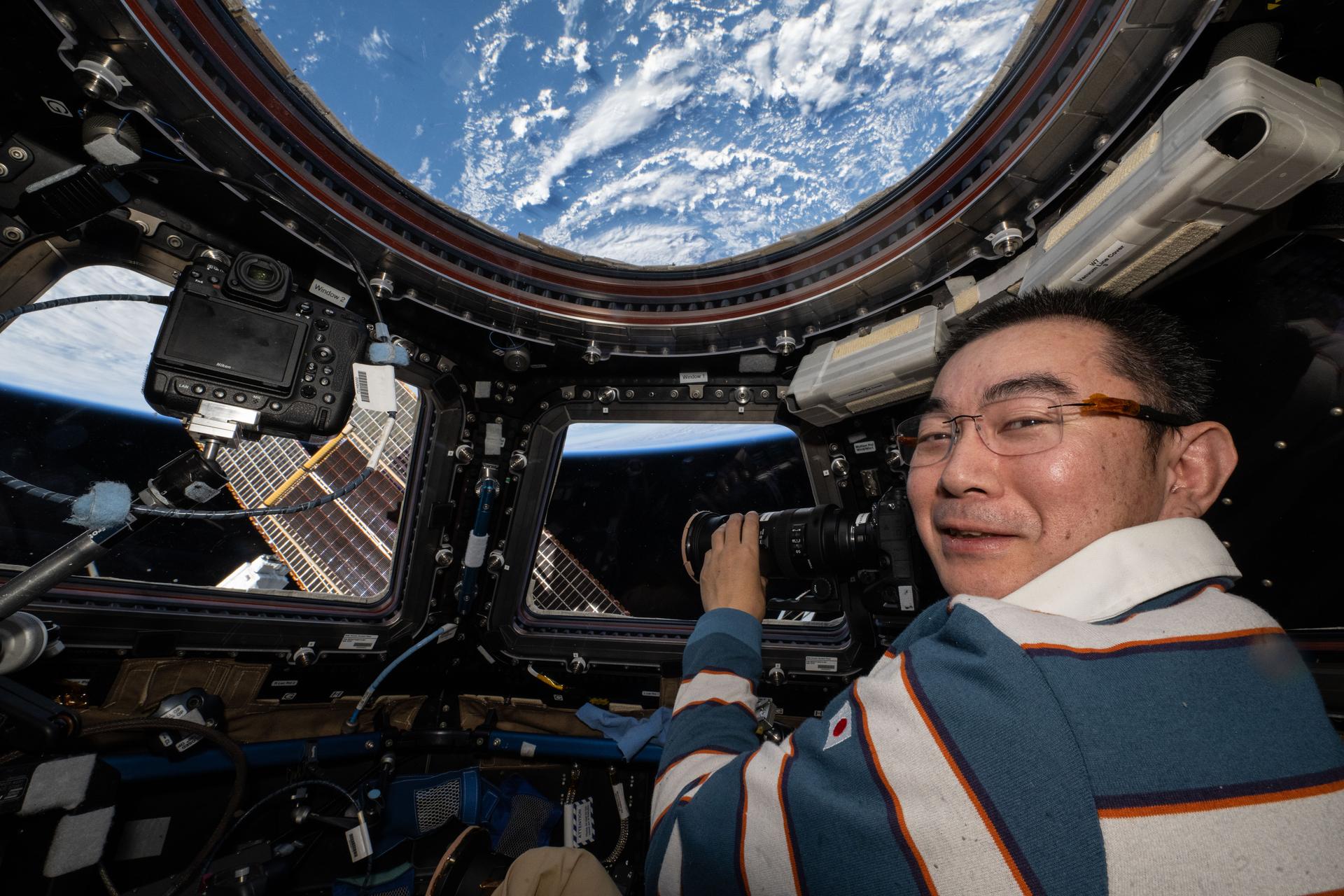 JAXA (Japan Aerospace Exploration Agency) astronaut and Expedition 73 Flight Engineer Kimiya Yui points a camera out a cupola window and photographs external International Space Station hardware. The orbital outpost was soaring 263 miles above the Atlantic Ocean northwest of Spain at the time of this photograph.