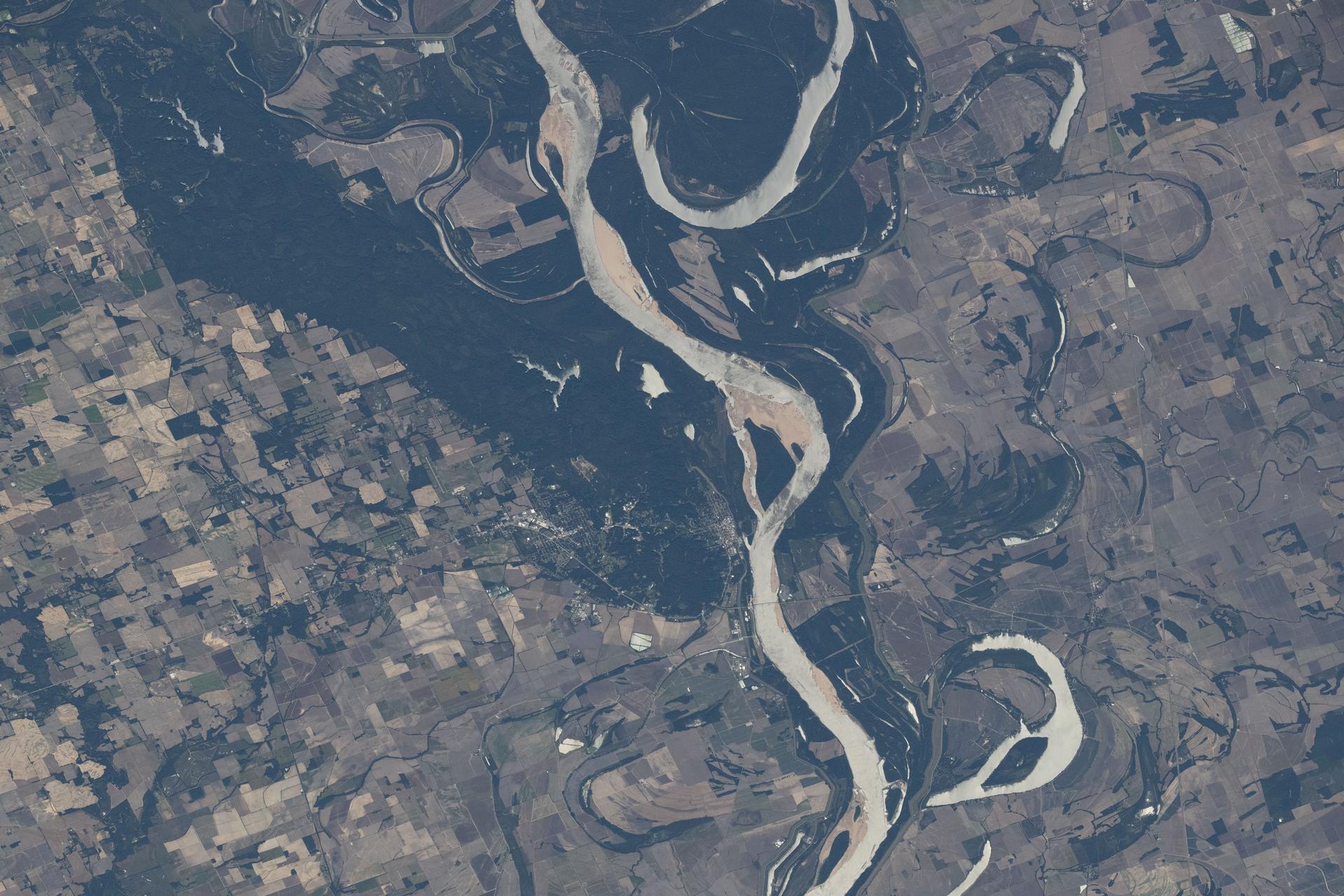 The Mississippi River separates Arkansas (left) from Mississippi in this view, with the St. Francis National Forest visible on the Arkansas side. Although not a true delta, the Mississippi Delta is a broad floodplain stretching from southern Illinois to Louisiana, with deep cultural roots in northern Mississippi. The International Space Station was orbiting 261 miles above Earth when this photograph was taken.