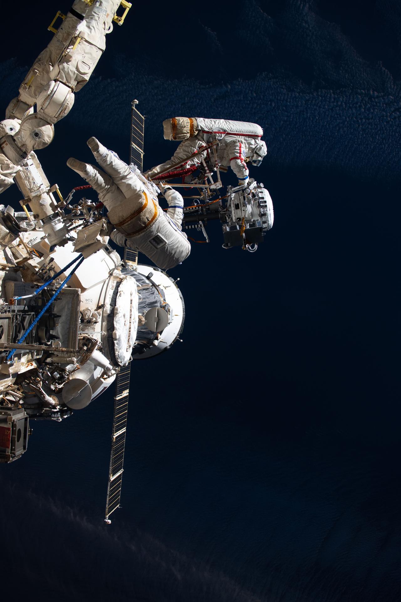 Roscosmos cosmonauts Alexey Zubritsky (left) and Sergey Ryzhikov (right) are pictured during a six-hour and nine-minute spacewalk outside the International Space Station's Roscosmos segment. The duo installed a semiconductor materials experiment, removed a high-resolution camera monoblock, cleaned a window on the Zvezda service module, and removed a materials exposure experiment container.