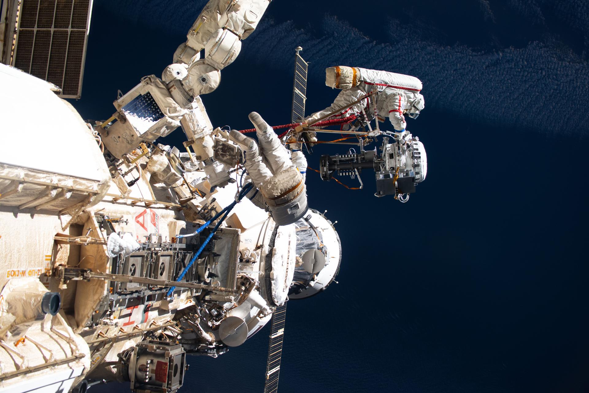 iss073e0881103 (Oct. 16, 2025) --- Roscosmos cosmonauts Alexey Zubritsky (center) and Sergey Ryzhikov (upper right) are pictured during a spacewalk outside the Roscosmos segment of the International Space Station. During the six-hour and nine-minute excursion, the duo installed a semiconductor materials experiment, removed a high-resolution camera monoblock, cleaned a window on the Zvezda service module, and dismantled a materials exposure container.
