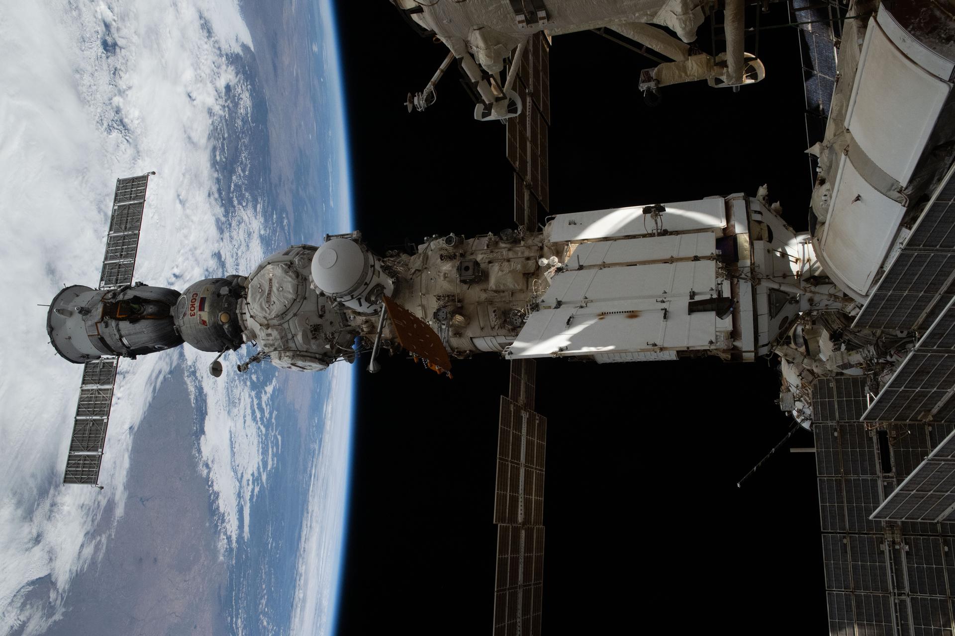 iss073e0883425 (Oct. 16, 2025) --- This view of the International Space Station’s Roscosmos segment shows (from left) the Soyuz MS-27 crew spacecraft docked to the Prichal module. Prichal is connected to the Nauka science module, which in turn is attached to the Earth-facing port of the Zvezda service module. At the time of this photograph, the orbital complex was soaring 265 miles above North Dakota.