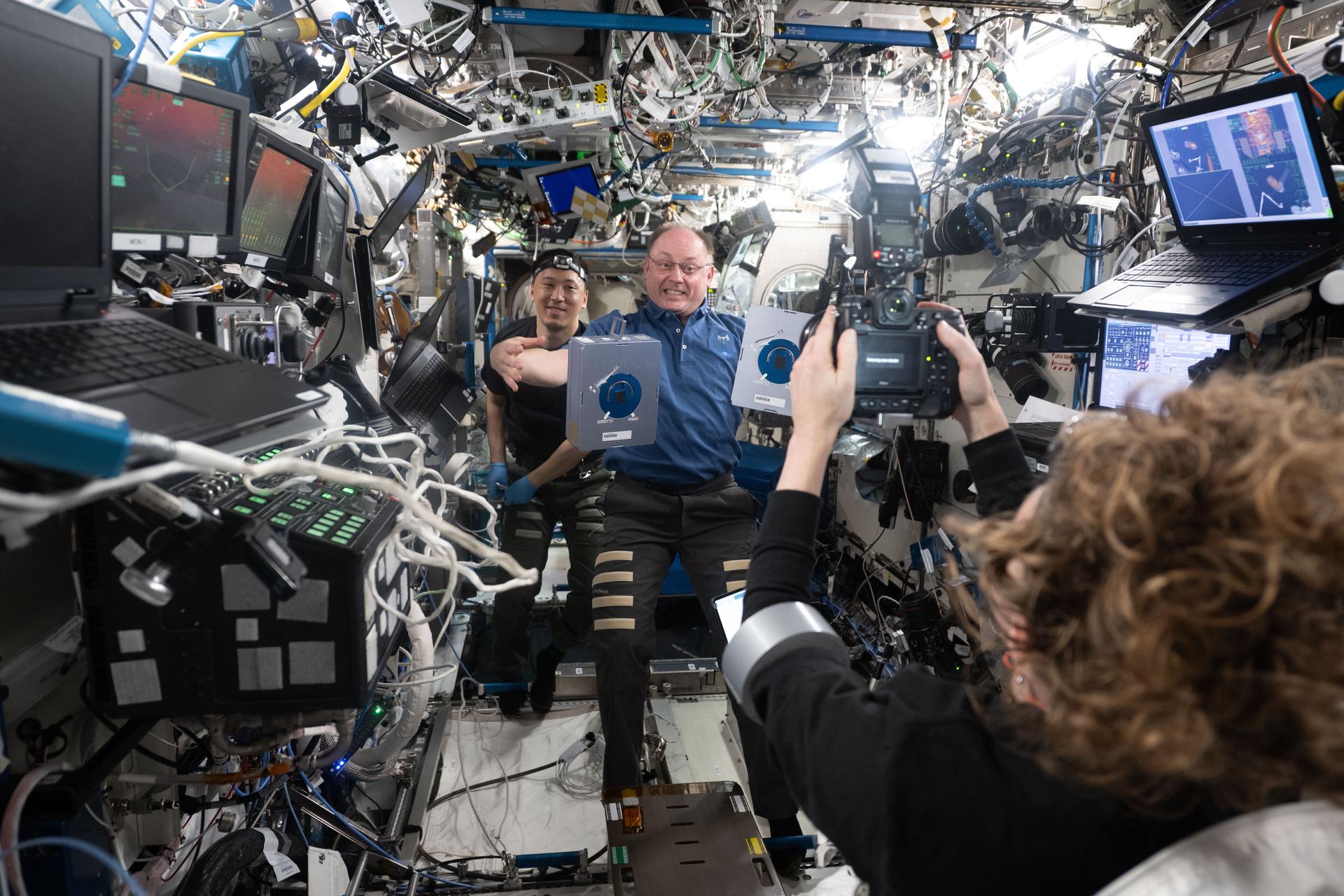 NASA astronauts (from left) Jonny Kim and Mike Fincke take a break during science and maintenance activities and smile for a portrait taken by NASA astronaut Zena Cardman inside the International Space Station's Destiny laboratory module.