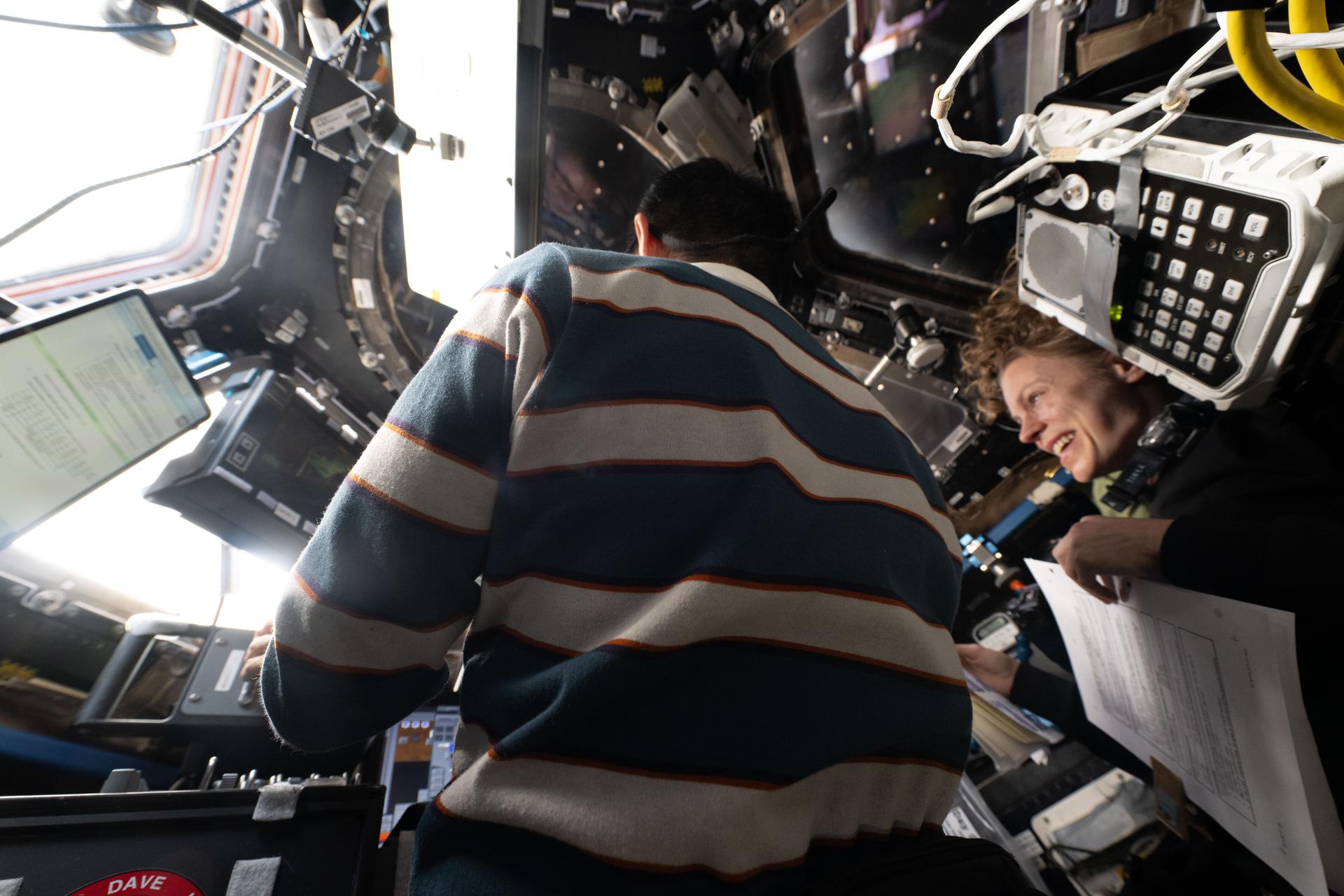 Expedition 73 Flight Engineers Kimiya Yui of JAXA (Japan Aerospace Exploration Agency) and Zena Cardman of NASA train inside the cupola to capture JAXA’s HTV-X1 cargo spacecraft using the Canadarm2 robotic arm. Yui will lead the robotic capture operations, while Cardman will monitor data and telemetry during HTV-X1’s approach and rendezvous with the International Space Station.
