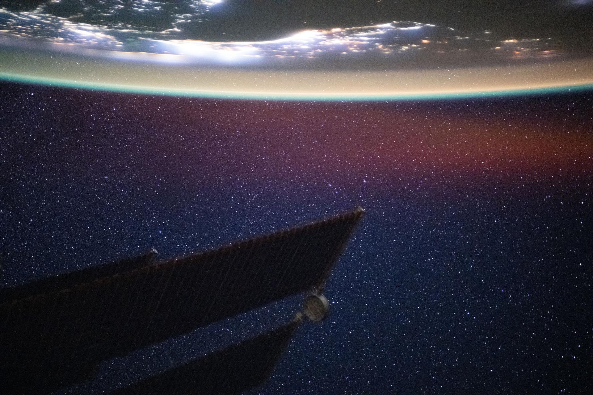 The Persian Gulf region—from Oman to the United Arab Emirates, with Iran's southwest coast visible across the geographically important waterway—is illuminated beneath a bright yellow-green airglow. This long-exposure photograph, taken at approximately 11:40 p.m. local time from the International Space Station as it orbited 259 miles above northwestern India, also captures the starry expanse of the night sky.