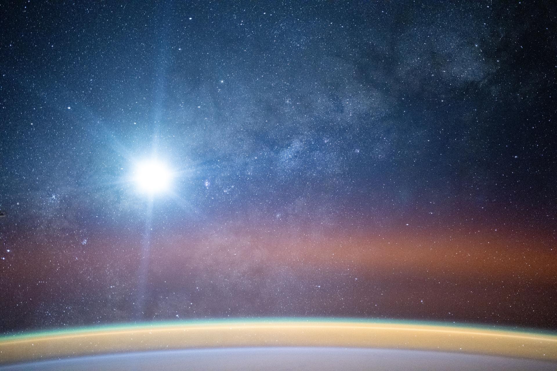 iss073e0982823 (Oct. 26, 2025) --- The Moon glares into a camera aboard the International Space Station as it orbited 259 miles above the Atlantic Ocean off the coast of Africa at approximately 10:49 p.m. local time. A bright airglow blankets Earth's horizon as the Milky Way illuminates the night sky.