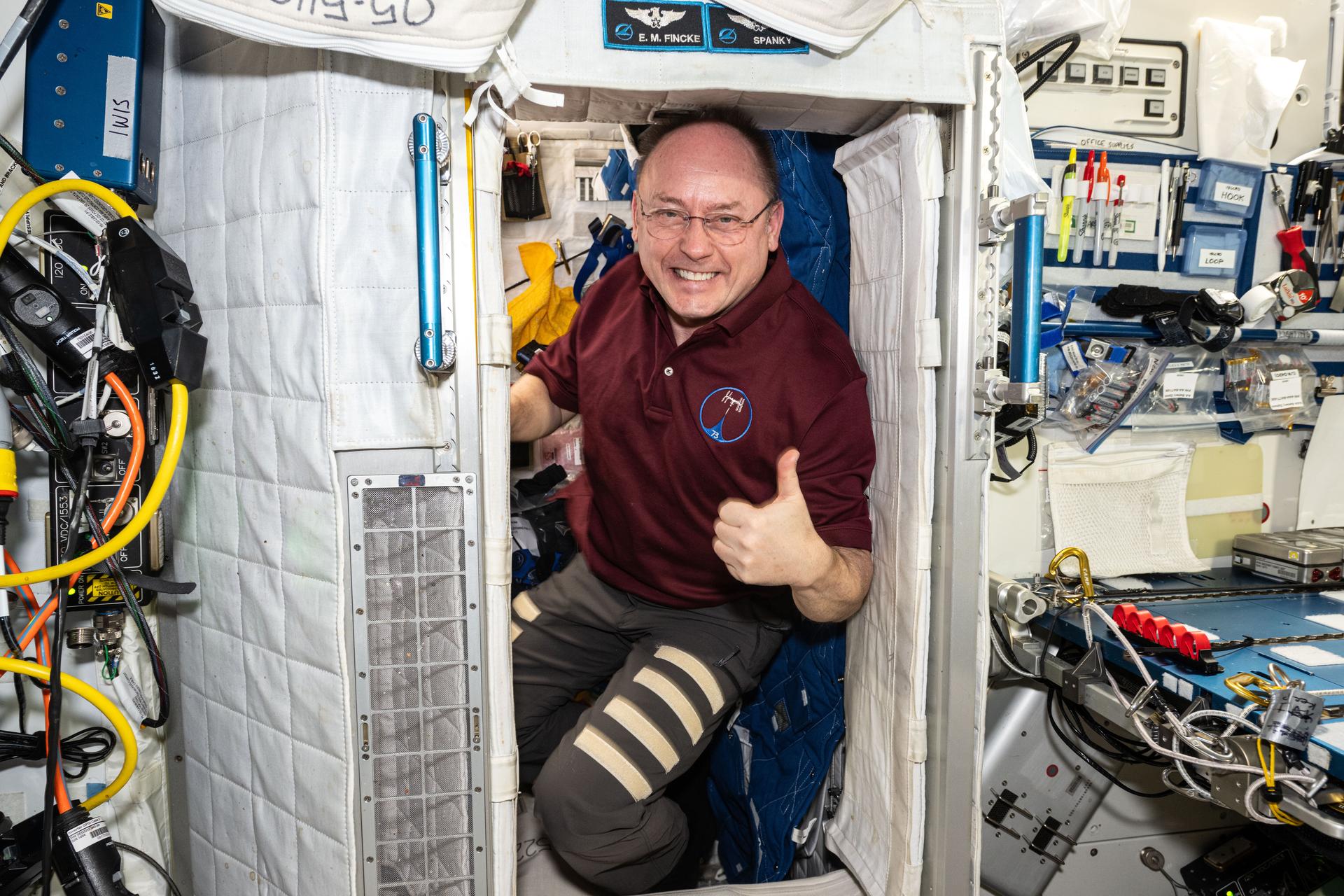 NASA astronaut and Expedition 73 Flight Engineer Mike Fincke poses for a portrait inside his crew quarters aboard the International Space Station's Harmony module.