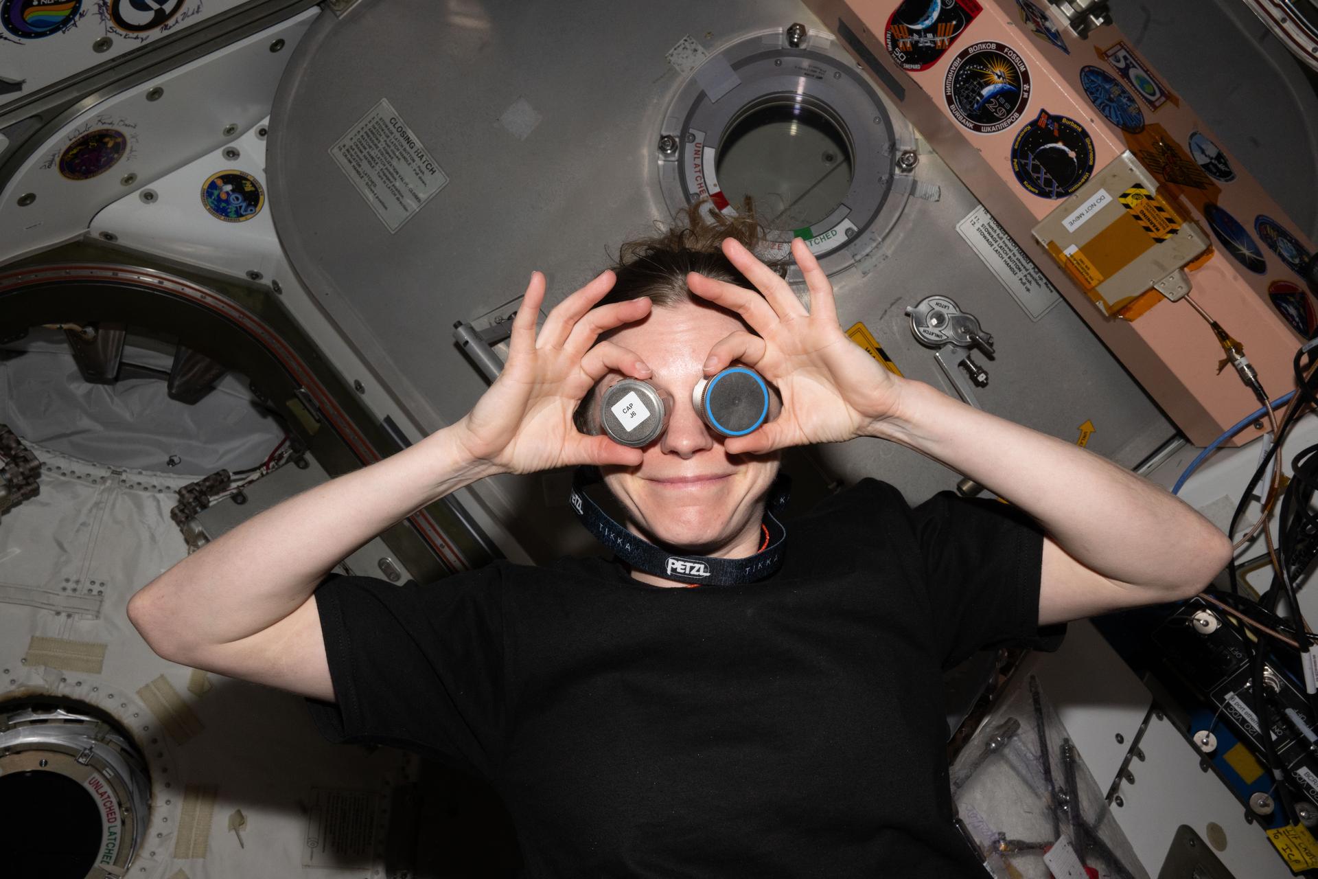 iss073e1162979 (Nov. 24, 2025) --- NASA astronaut and Expedition 73 Flight Engineer Zena Cardman poses for a playful portrait before closing the hatch to Northrop Grumman's Cygnus cargo craft attached to the International Space Station's Unity module.