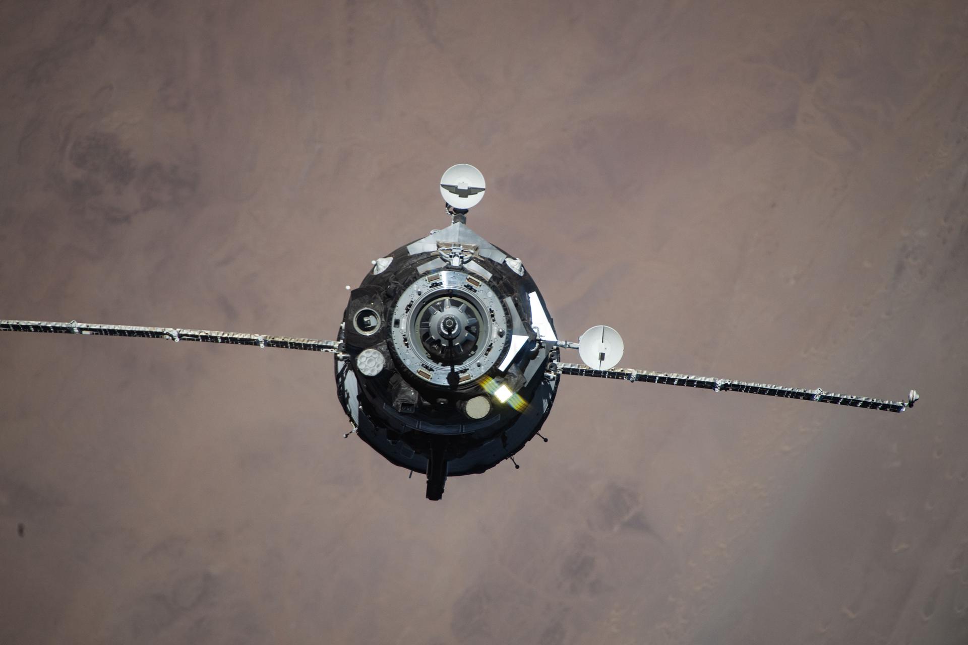 The Soyuz MS-28 crew spacecraft carrying NASA astronaut Chris Williams and Roscosmos cosmonauts Sergey Kud-Sverchkov and Sergei Mikaev approaches the International Space Station. Both spacecraft were orbiting 262 miles above the hot desert landscape of Western Sahara at the time of this photograph.