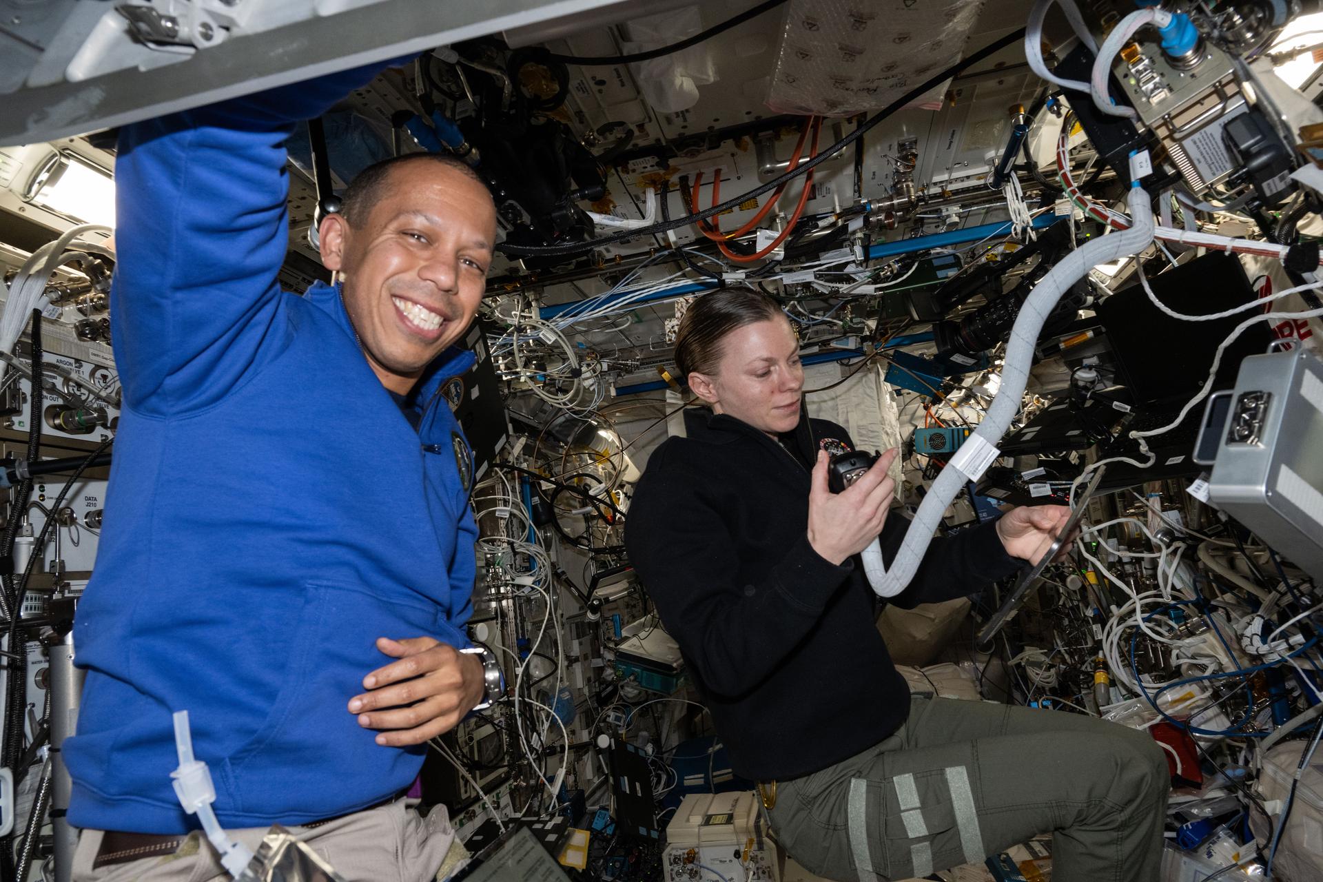 Expedition 73 Flight Engineers Chris Williams and Zena Cardman, both NASA astronauts, work together inside the International Space Station's Columbus laboratory module. Cardman was helping new NASA Flight Engineer Chris Williams familiarize himself with station hardware, operations, and systems during his second day aboard the orbital outpost.