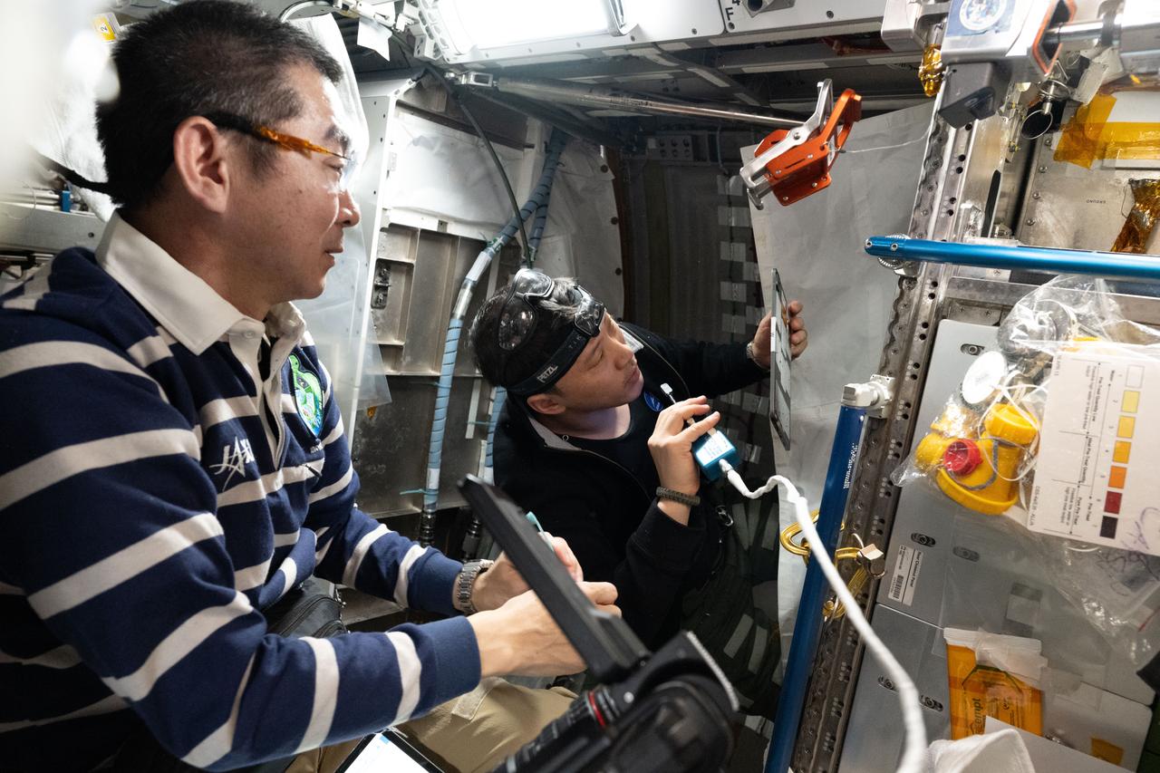 iss073e1199016 (Nov. 20, 2025) --- Expedition 73 Flight Engineers (from left) Kimiya Yui of JAXA (Japan Aerospace Exploration Agency) and Jonny Kim of NASA work together swapping thermal control system hoses on the COLBERT treadmill located inside the Tranquility module. The pair temporarily uninstalled the station’s bathroom, or waste and hygiene compartment, to access the life support hoses.