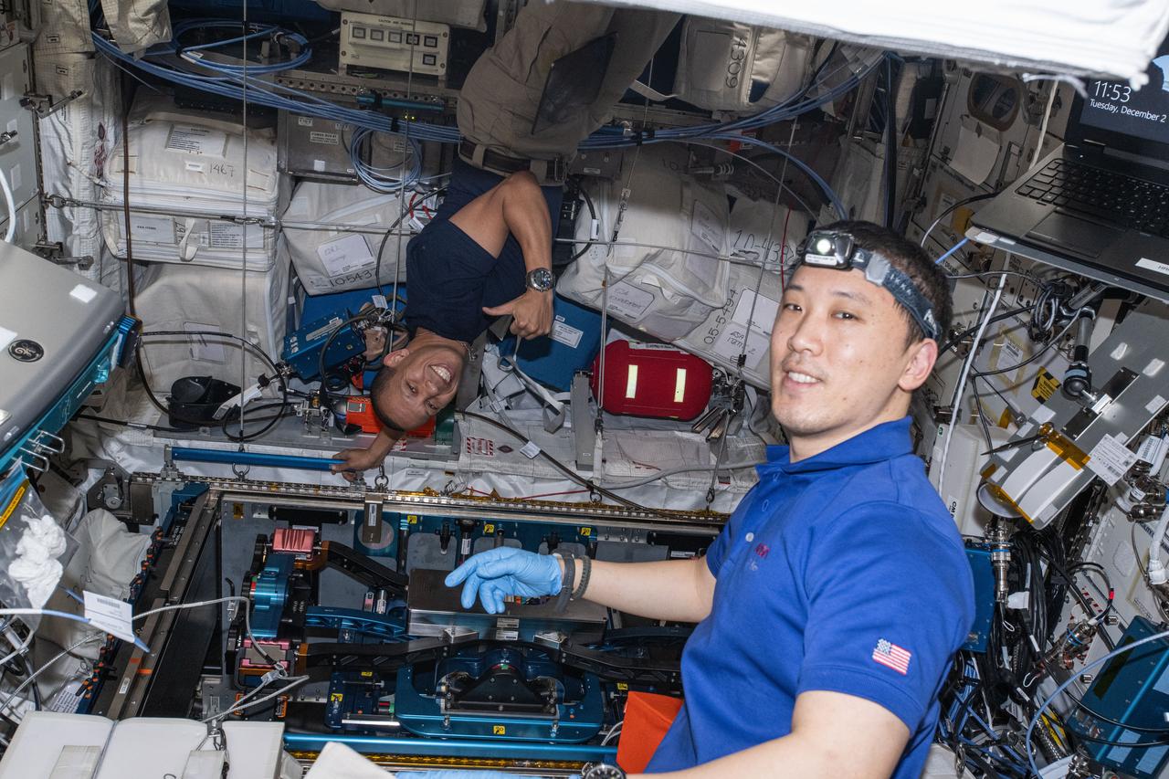 iss073e1228220 (Dec. 2, 2025) --- Expedition 73 Flight Engineers (from left) Chris Williams and Jonny Kim, both NASA astronauts, work together inspecting and cleaning the Enhanced European Exploration Exercise Device (E4D) inside the International Space Station's Columbus laboratory. The E4D is being tested on the orbital outpost for its ability to provide bicycling, rowing, and resistance exercises to protect a crew member’s muscles, bones, and heart health in microgravity.